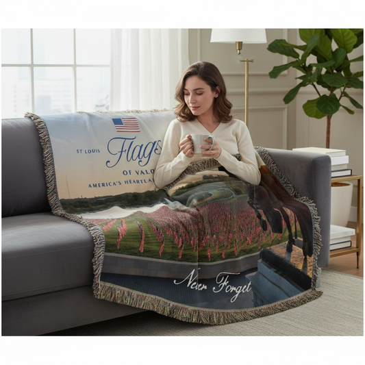 Woman sitting on a couch with a decorative blanket featuring text and graphics.